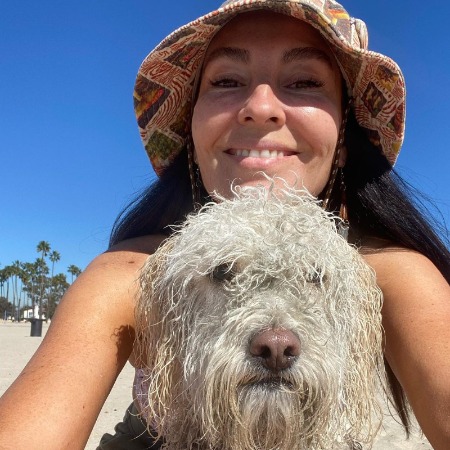 Gabriel Hogan's wife their dog Rocky in the beach.